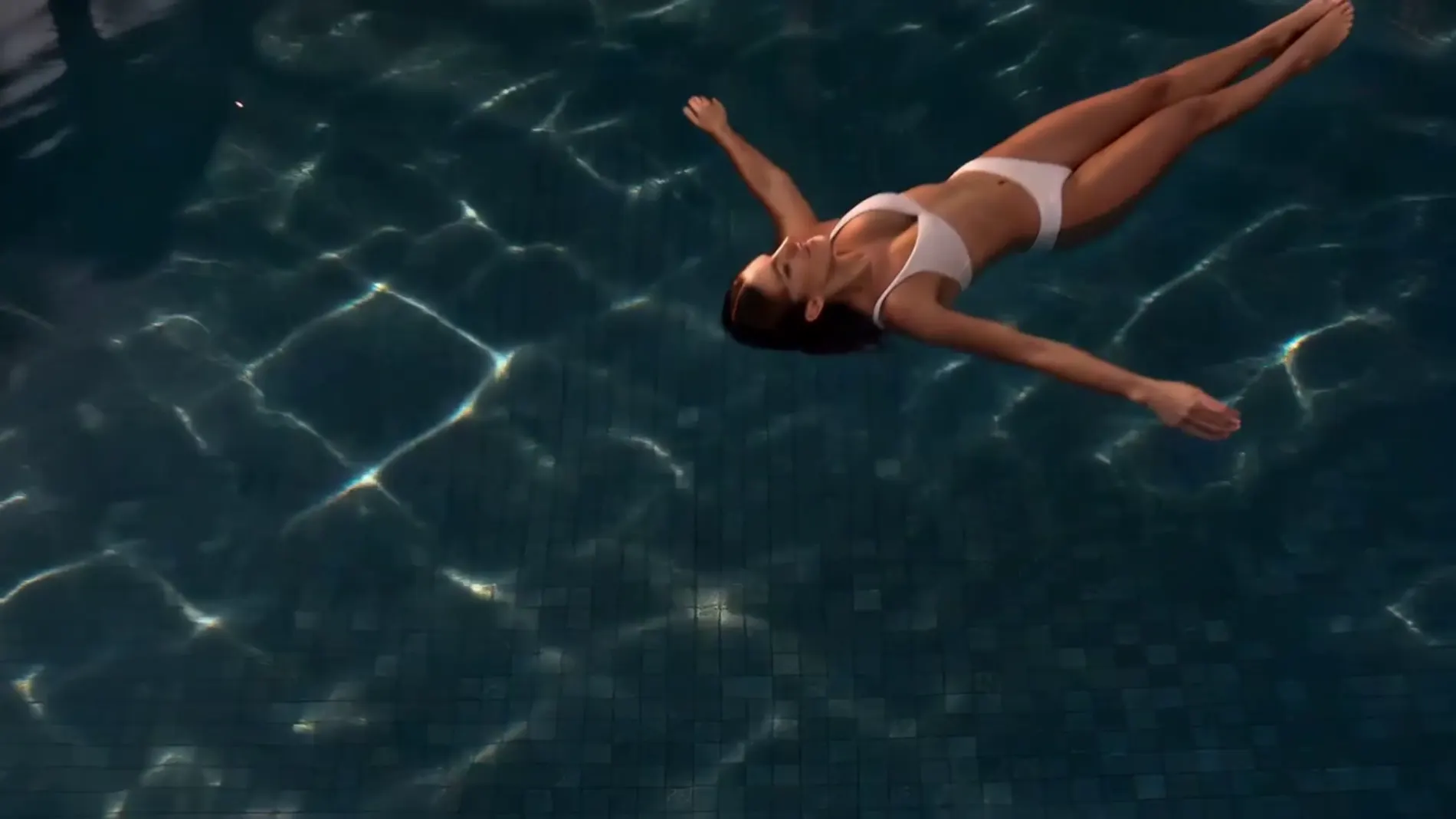 Overhead shot of a guest floating in a resort pool