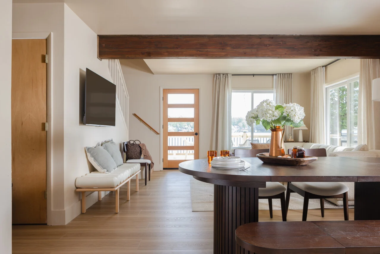 Photograph of the dining table and living room under the timber beam, built